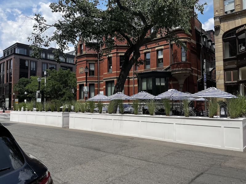 white wall parking seating structure in front of Saltie Girl Boston