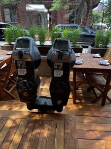 Parking meters encased in wood in the parking patio